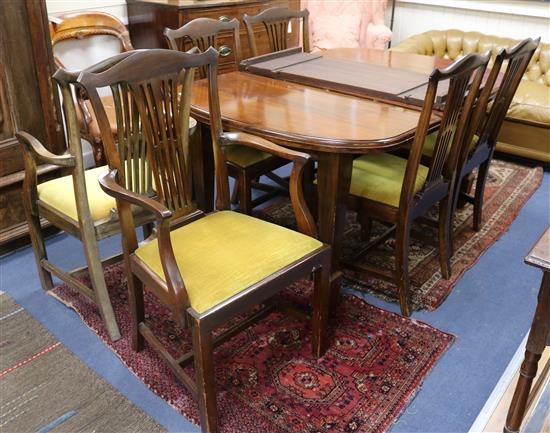A 1920s extending mahogany extending dining table and a set of six chairs, two with arms